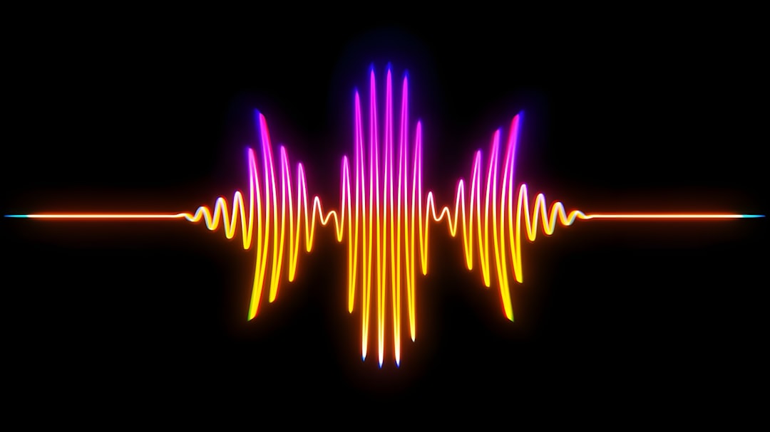A colorful sound wave graphic with pink and orange hues against a black background.