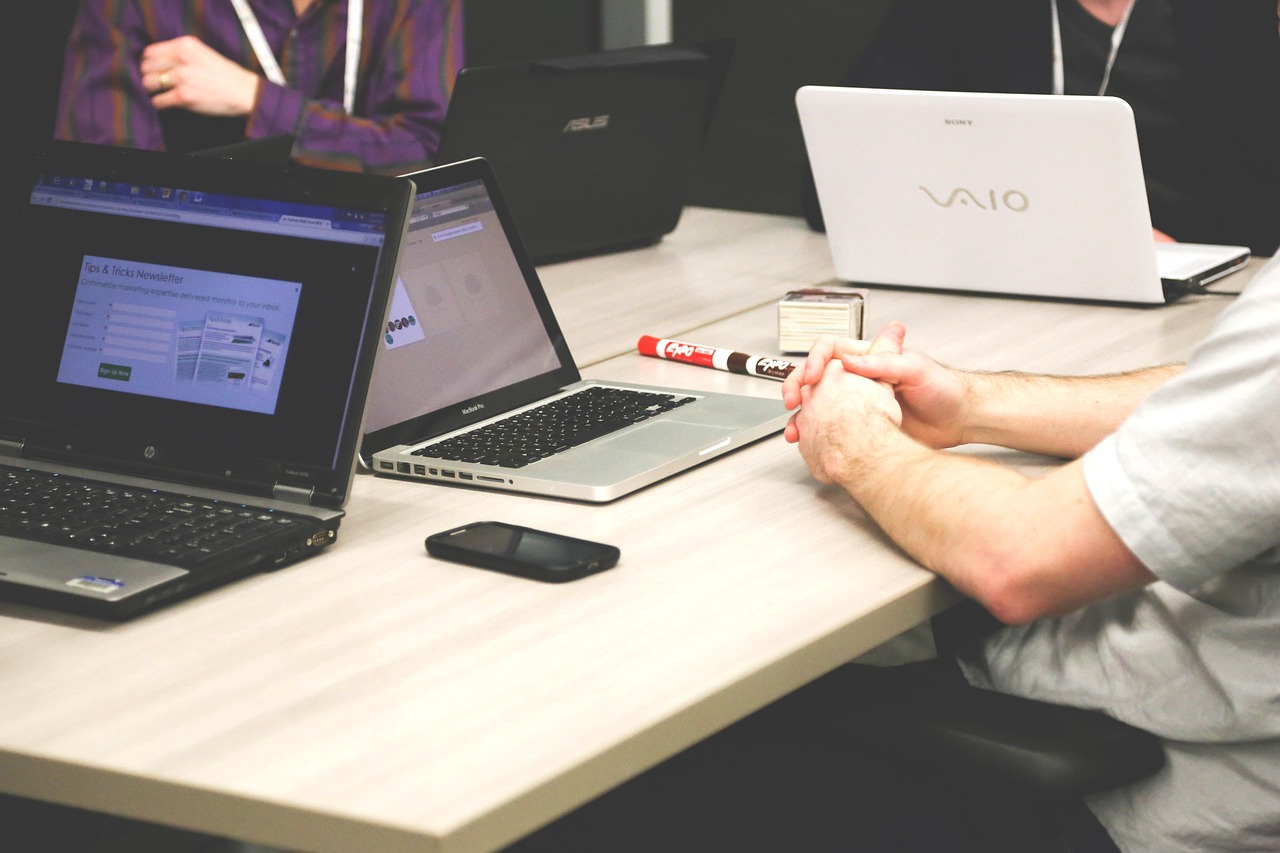 Laptops, meeting, businessmen — Next-Level Lead Generation: Torn Digital's Data-Driven Solutions